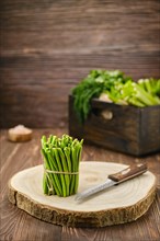 Fresh green beans on wooden cutting board