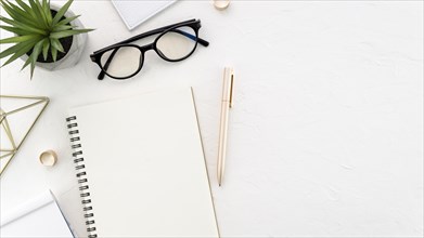 Desktop with glasses and notebook