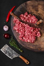 Top view of fresh beef minced meat on wooden chopping stump
