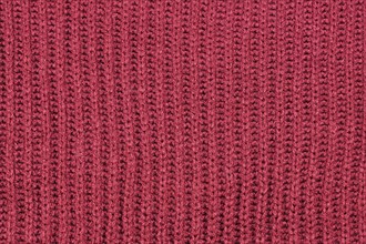 Close up of knitted pattern on blue wool pullover