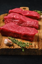 Closeup view of raw beef steak with spice on cutting board