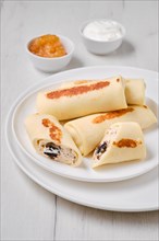 Thin crepe stuffed with curd and raisins