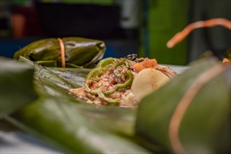 Closeup of raw ingredients for the elaboration of a Nicaraguan nacatamal. Nacatamal ingredients on banana leaves