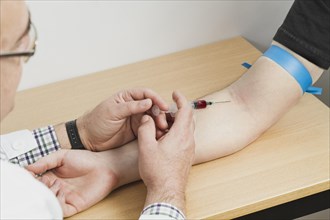 Doctor making blood test