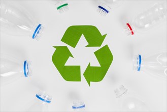Empty plastic bottles around recycling icon