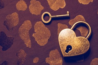 Heart shaped lock and key on an abstract background