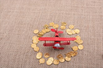Fake gold coins around the retro model airplane