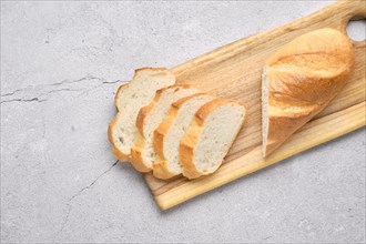 Fresh loaf of wheat bread on wooden cutting board