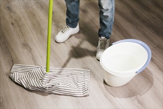 Close up man mopping floor