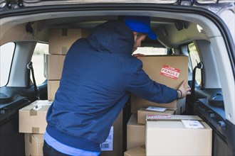Deliveryman car with carton boxes