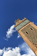 Minaret of the 12th century Koutoubia Mosque against a blue sky