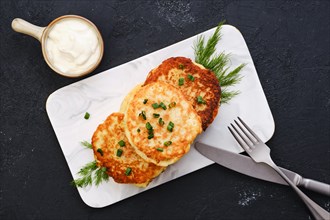 Top view of potato pancakes stuffed with chopped salmon meat