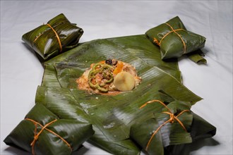 Top View of raw ingredients of the Nicaraguan nacatamal on banana leaves. Raw ingredients for the preparation of the traditional Nacatamal
