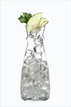 Transparent jar with ice and apple with mint as a topping