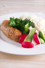 Fried sausage with rice and fresh cucumber and radish