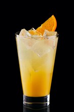 Cold fizz cocktail with orange isolated on black background