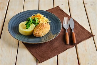 Chicken cutlet in breading with mashed potato and pickled cabbage