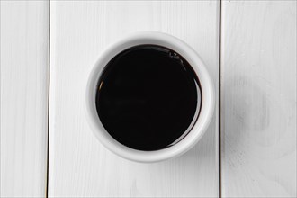 Top view of soy sauce in ceramic gravy boat