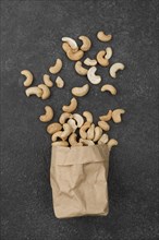 Paper bag filled with healthy raw cashew nuts. Resolution and high quality beautiful photo