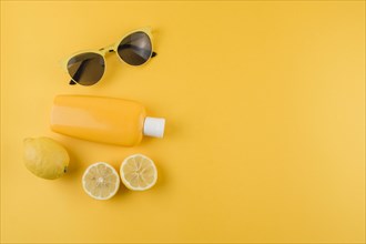 Sunscreen lotion lemons sunglasses yellow background. Resolution and high quality beautiful photo