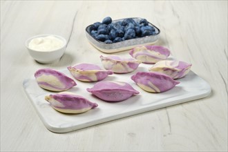Frozen pierogi with blueberry and sour cream