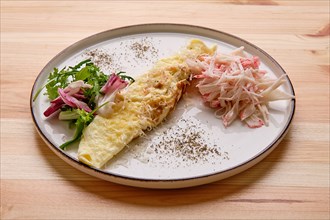 Omelette with crab meat and salad