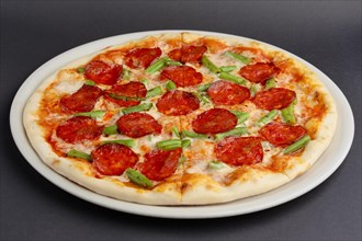 Pizza pepperoni on black table