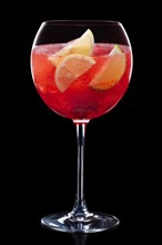 Cold sangria in a wine glass isolated on black