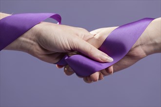 Women hands holding purple satin ribbon. Resolution and high quality beautiful photo