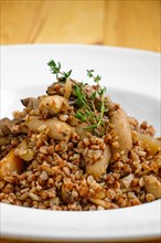 Close up view of boiled buckwheat with marinated mushrooms