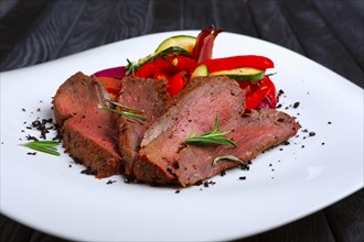Roasted beef cutted on slices with grilled bell pepper