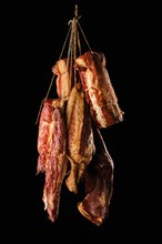 Assortment of air dried and smoked lamb and beef meat on hanger