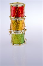Little colorful toy drums on a white background
