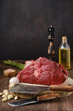 Raw fresh beef shank cross-cut on wooden background