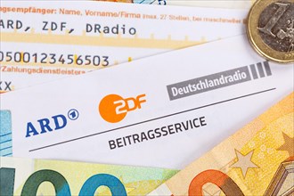 Contribution service of ARD and ZDF Rundfunkgebuehr GEZ with money in Stuttgart