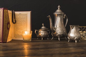 Quran candle near tea set