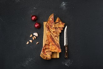 Air dried lamb ribs on wooden cutting board