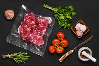 Vacuum sealed lamb neck meat with ingredients for cooking