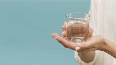 Woman holding glass filled with water copy space. Resolution and high quality beautiful photo