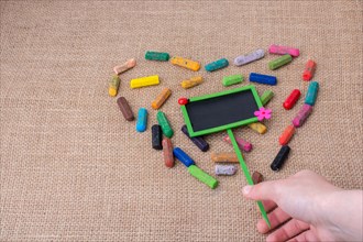 Notice board in the middle of crayons form a heart shape