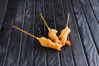 Appetizer for reception. Deep-fried shrimp on skewer