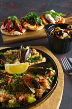 Set of tapas and paella with shrimps and mussels