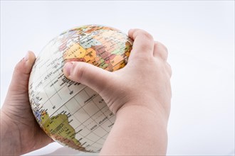 Child holding a globe in his hand on a white background
