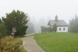 Chapel on the Neureuth with hiking trail in the fog