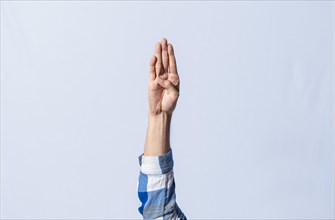 Hand gesturing the letter B in sign language on isolated background. Man hand gesturing the letter B of the alphabet isolated. Letters of the alphabet in sign language