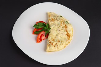 Top view of omelet with ham and vegetables