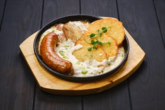 Potato fritters with with fried german sausage and pork belly slices