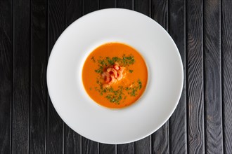Top view of plate of soup with shrimps