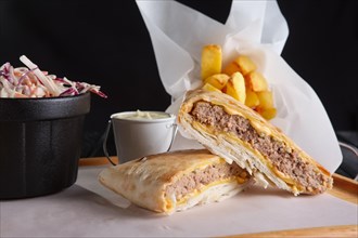 Beef cutlet with cheese rolled in pita with fried potato and red cabbage