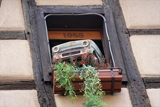 Decorated window on a half-timbered house in the historic old town of Riquewihr